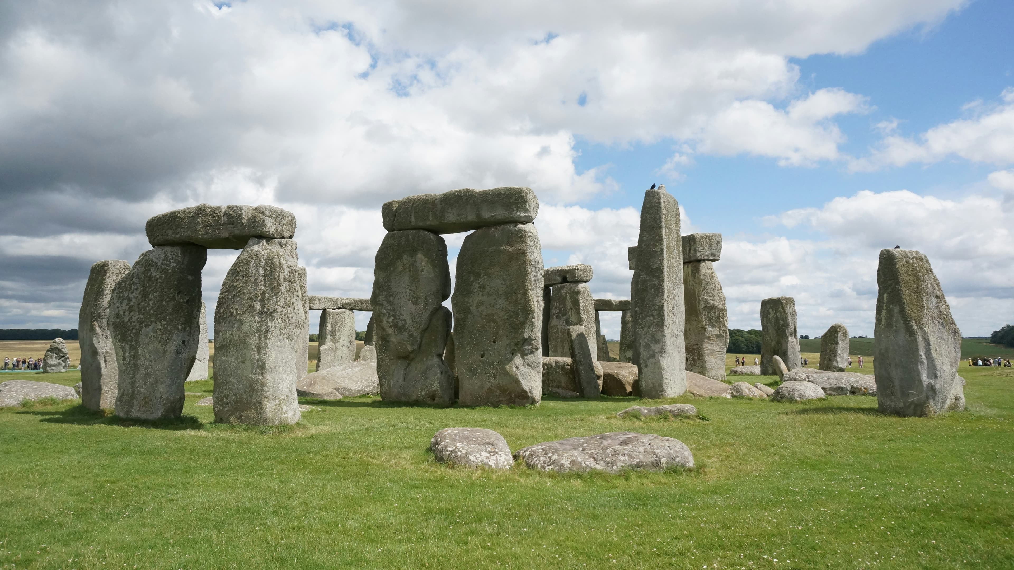 a group of stonehenges in a grassy field zH_1u_TNGts