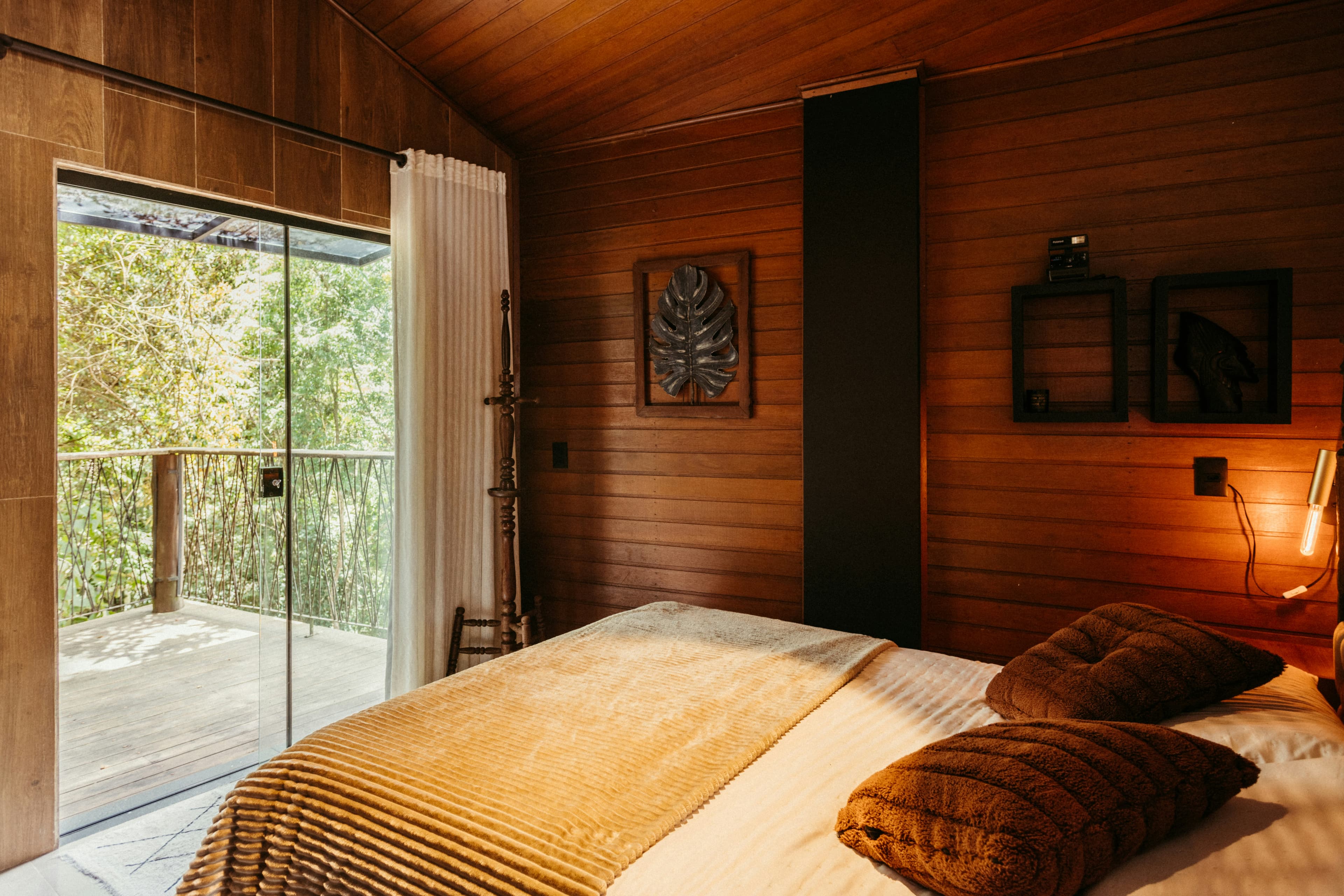 a bedroom with a bed and a sliding glass door nNlqTQiDaco